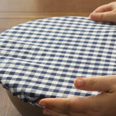 a fabric bowl cover covering a stainless steel bowl